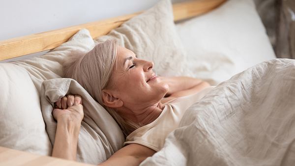 Frau schläft zufrieden ein - Foto: iStock/fizkes