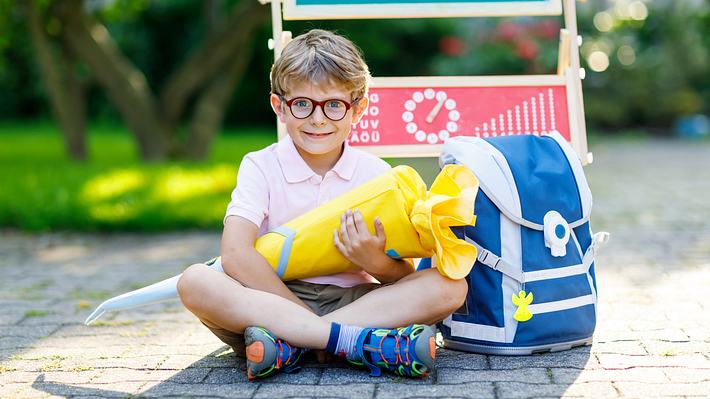 Schültüte füllen: Ein Junge hält stolz seine Schultüte zur Einschlung in die Grundschule in der Hand - Foto: iStock/ romrodinka 