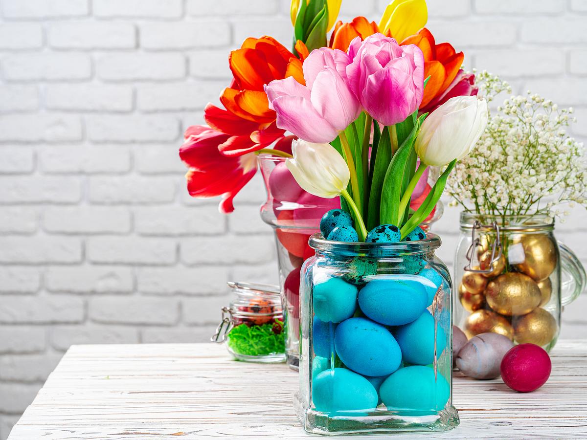 Vase gefüllt mit Ostereiern und Blumen